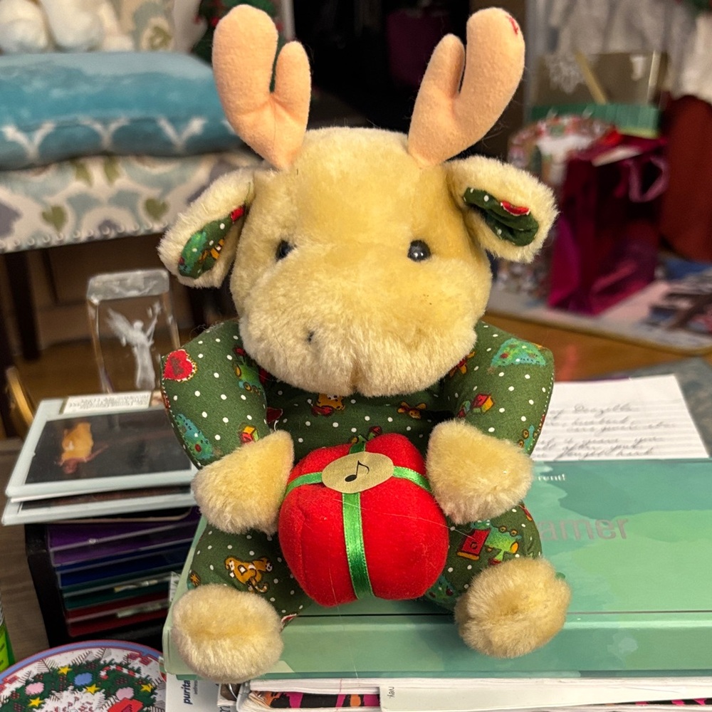 Plush Reindeer Toy with Green Outfit and Red Gift